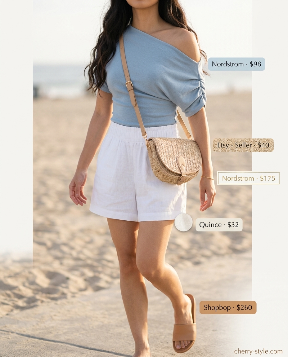 Sky blue one-shoulder tank with linen shorts, leather slides, and straw crossbody bag.