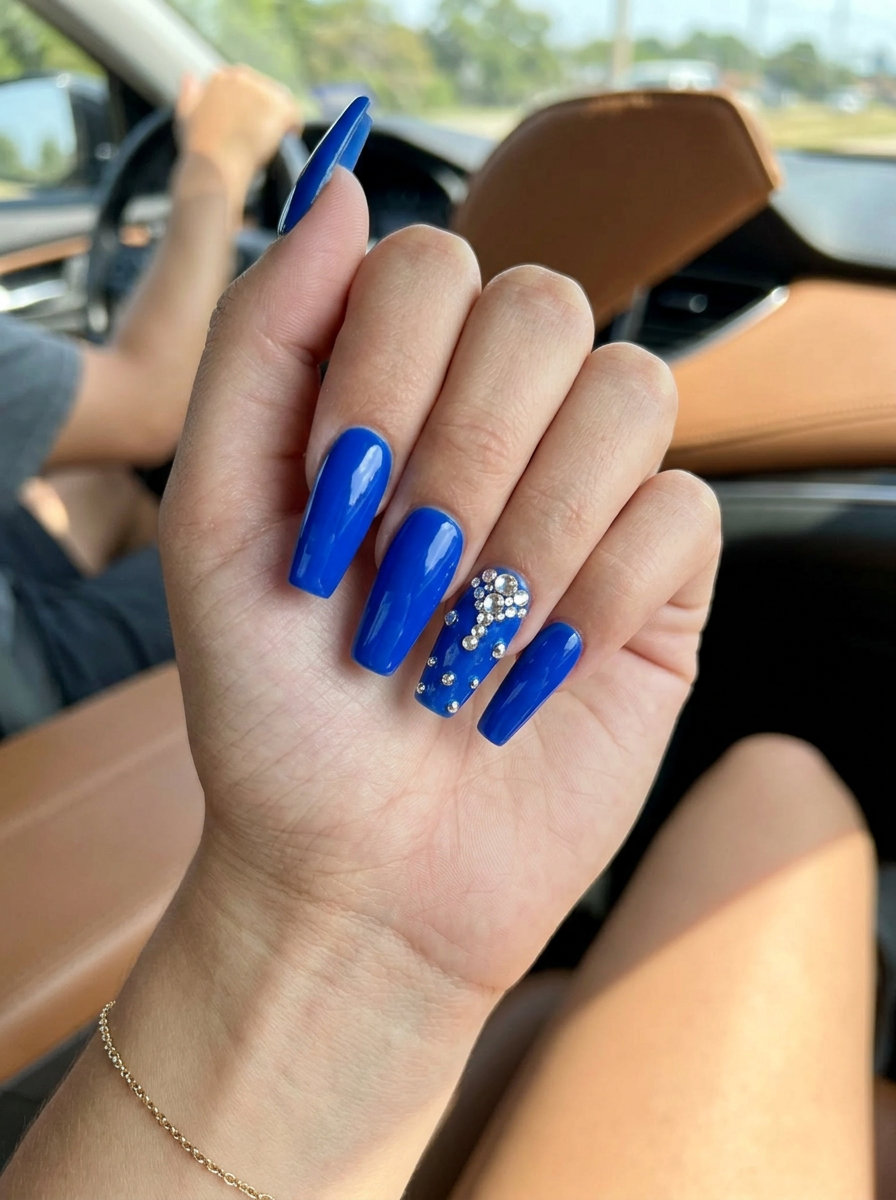 Cobalt Blue Jewel Sparkle Stiletto nails with rhinestones for summer 2026 festivals and parties.