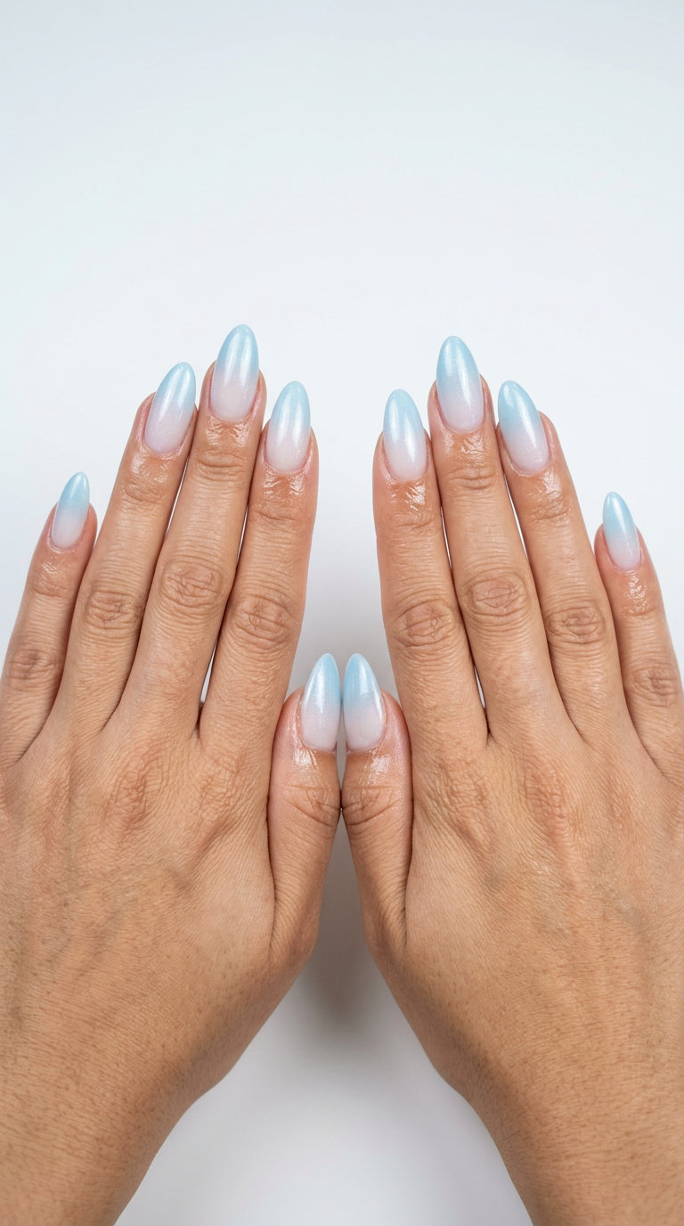Soft sky blue gradient almond nails with shimmer for summer evenings 2026.
