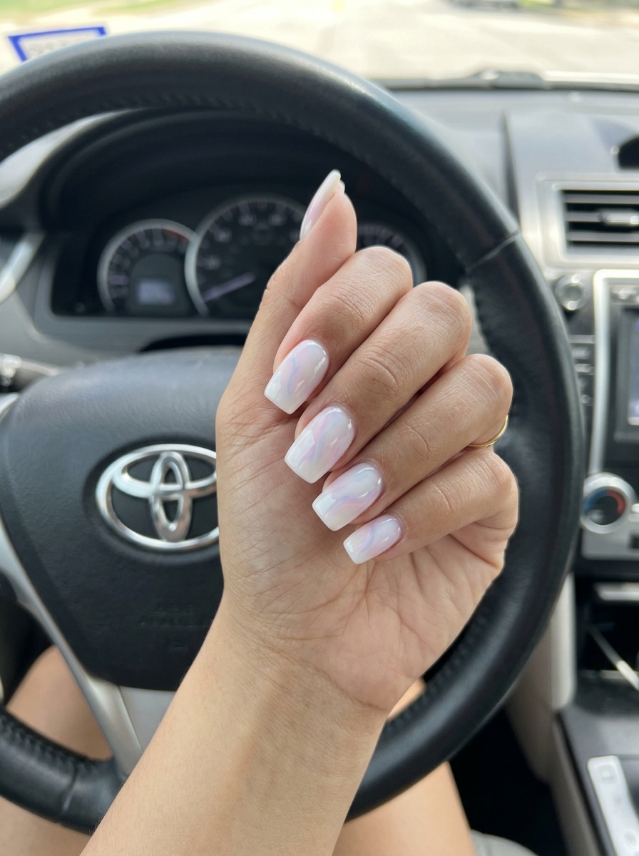 Cute summer nails 2026: Milky white builder gel with pastel swirls, soft coffin shape, romantic bridal shower style.