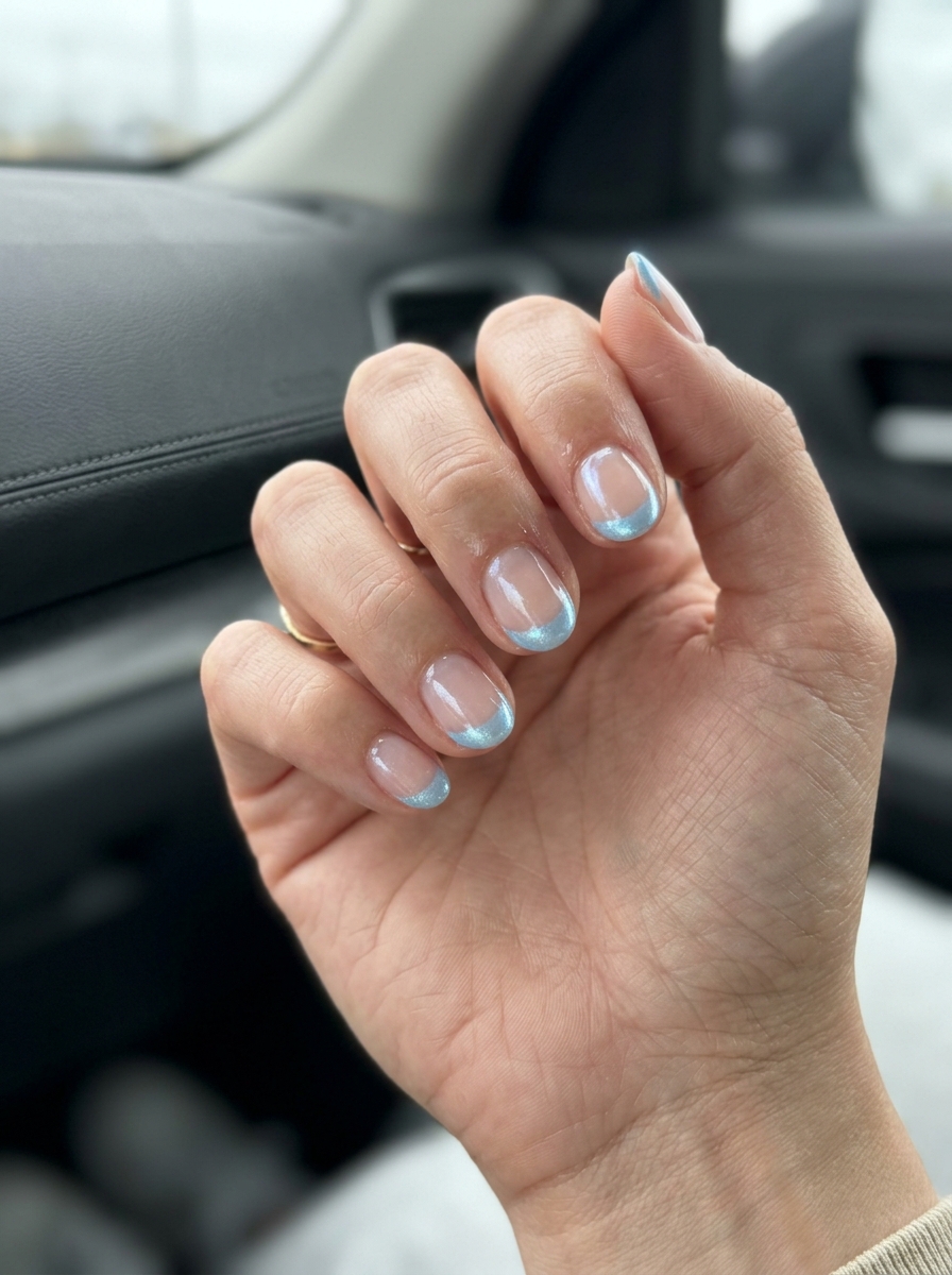 Cute summer nails 2026: Playful sky blue shimmer French tips for vacation and spring.