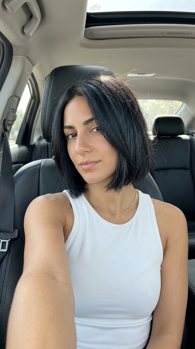 short espresso brunette bob haircut with blue-black undertones, razored ends, no bangs — edgy professional