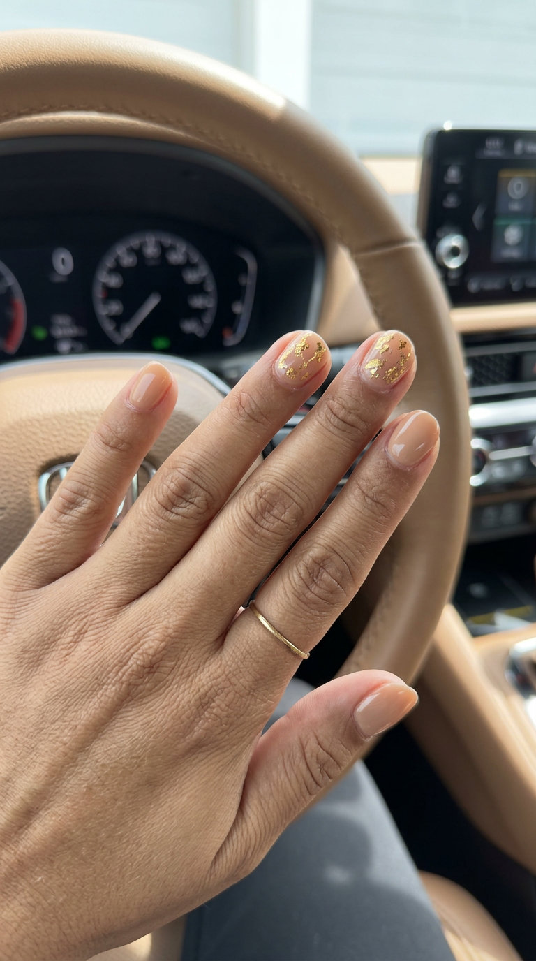Warm beige nude short square nails with metallic gold foil accents. June manicure ideas - summer trends 2026.