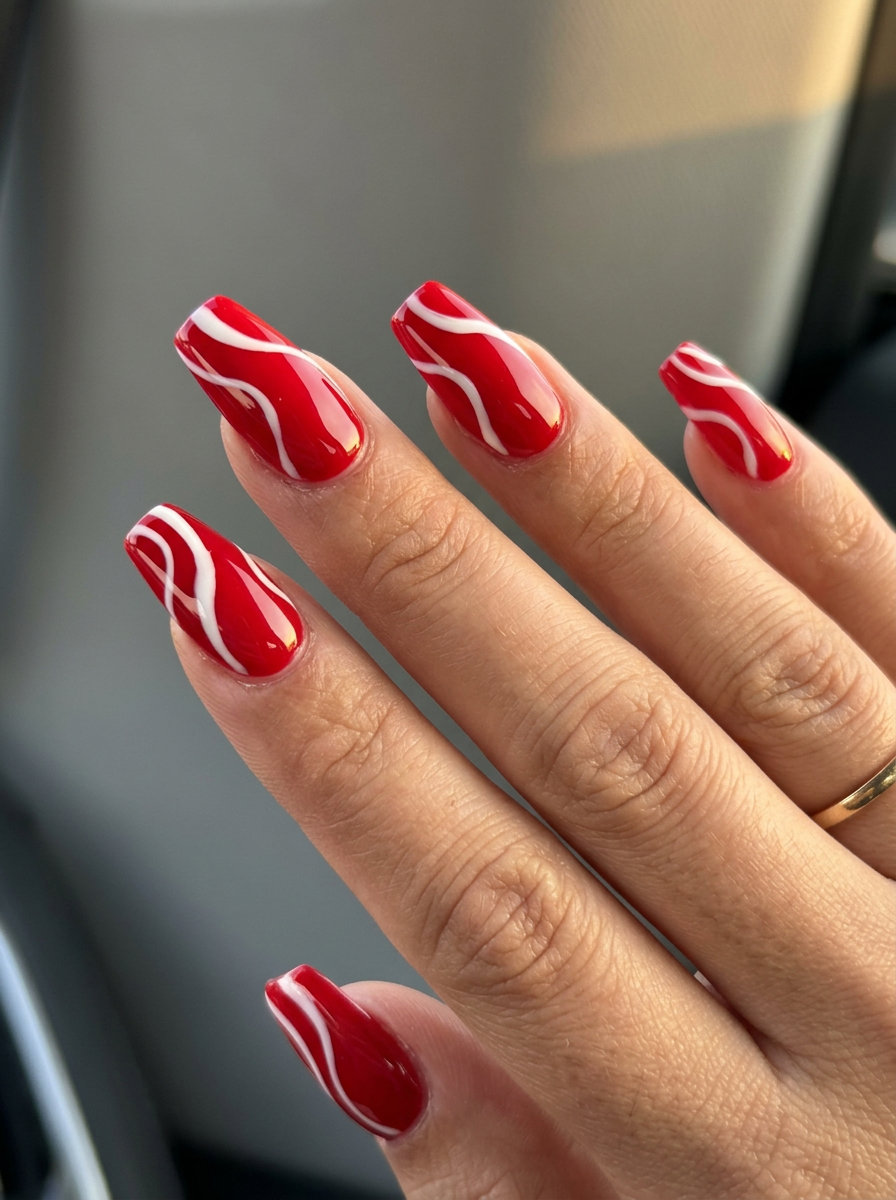 Fiery abstract red swirls nails for summer 2026, ideal for nights out and art events.