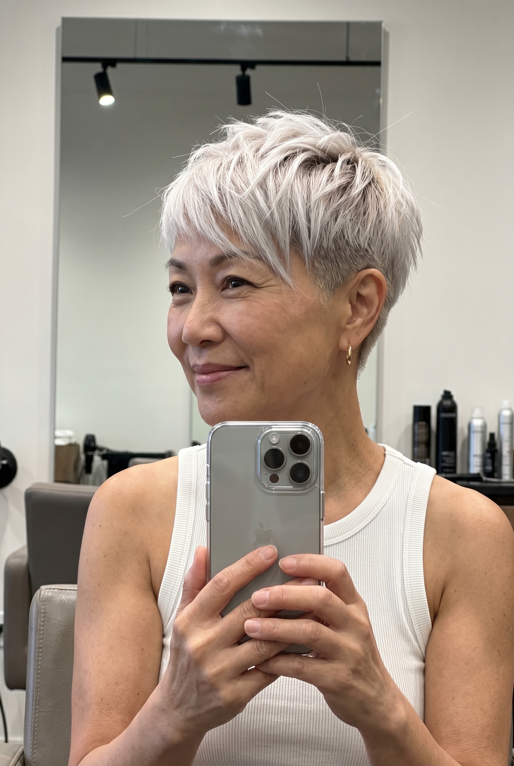 very short platinum blonde pixie with ash shadow root and asymmetrical fringe for festivals