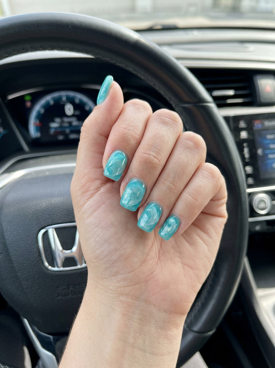 Aqua jelly shell summer nails 2026 with pearlescent swirls and glitter for beach parties.