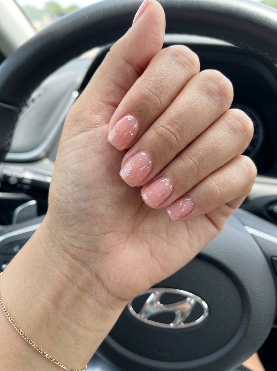 Simple short summer nails 2026: Sheer pink jelly with gold foil flakes for date night. Romantic & whimsical.