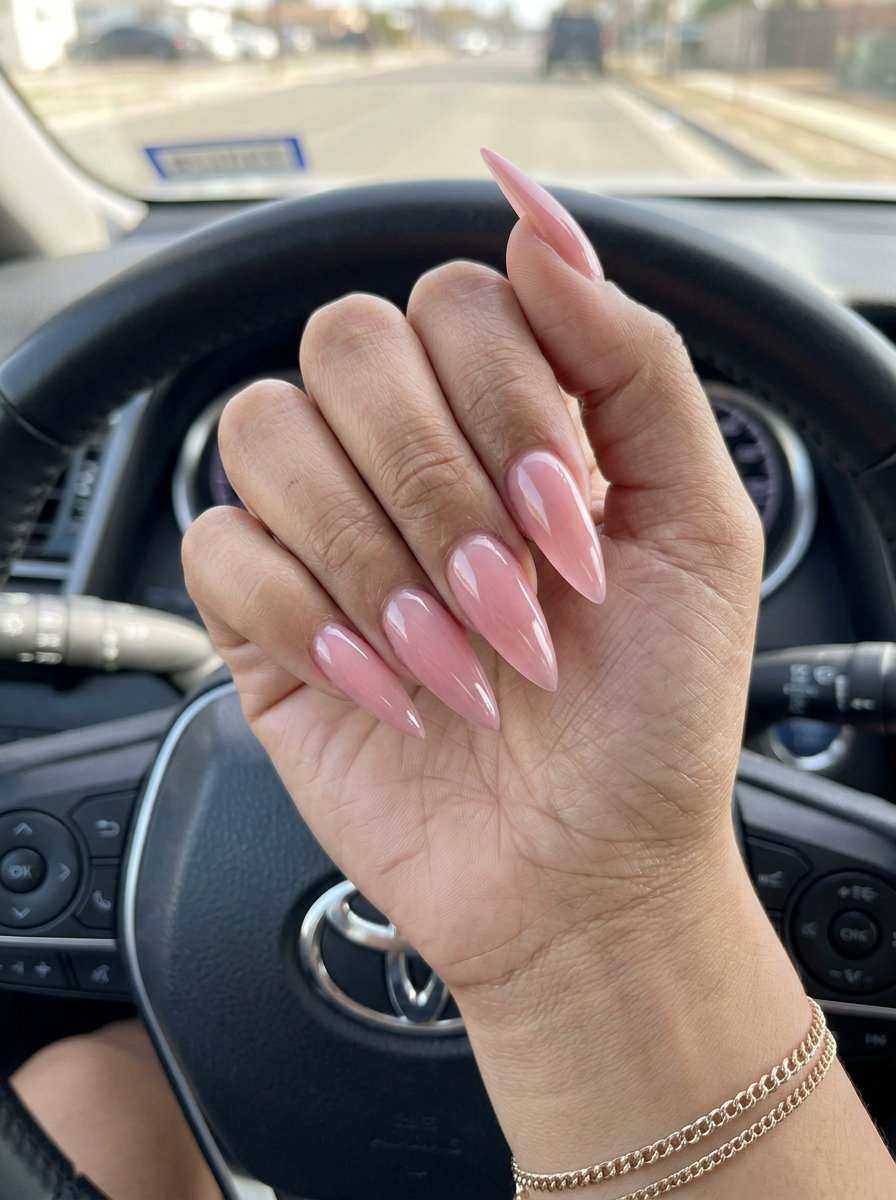 Sultry sheer pink stiletto acrylic nails for a glamorous evening look. Bold summer acrylic nail designs 2026.