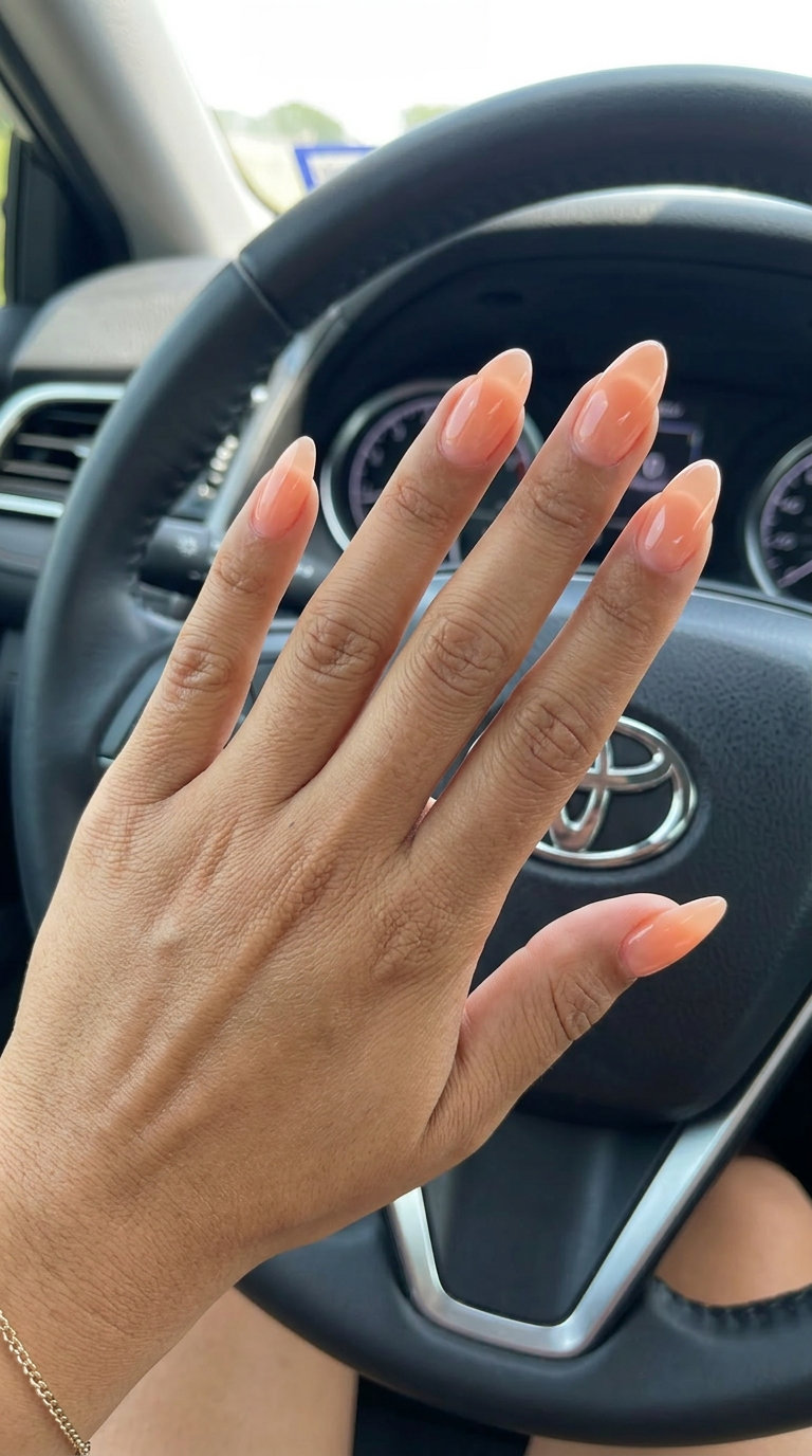 Bohemian light peach jelly almond nails for vacation. Simple summer acrylic nail designs 2026.