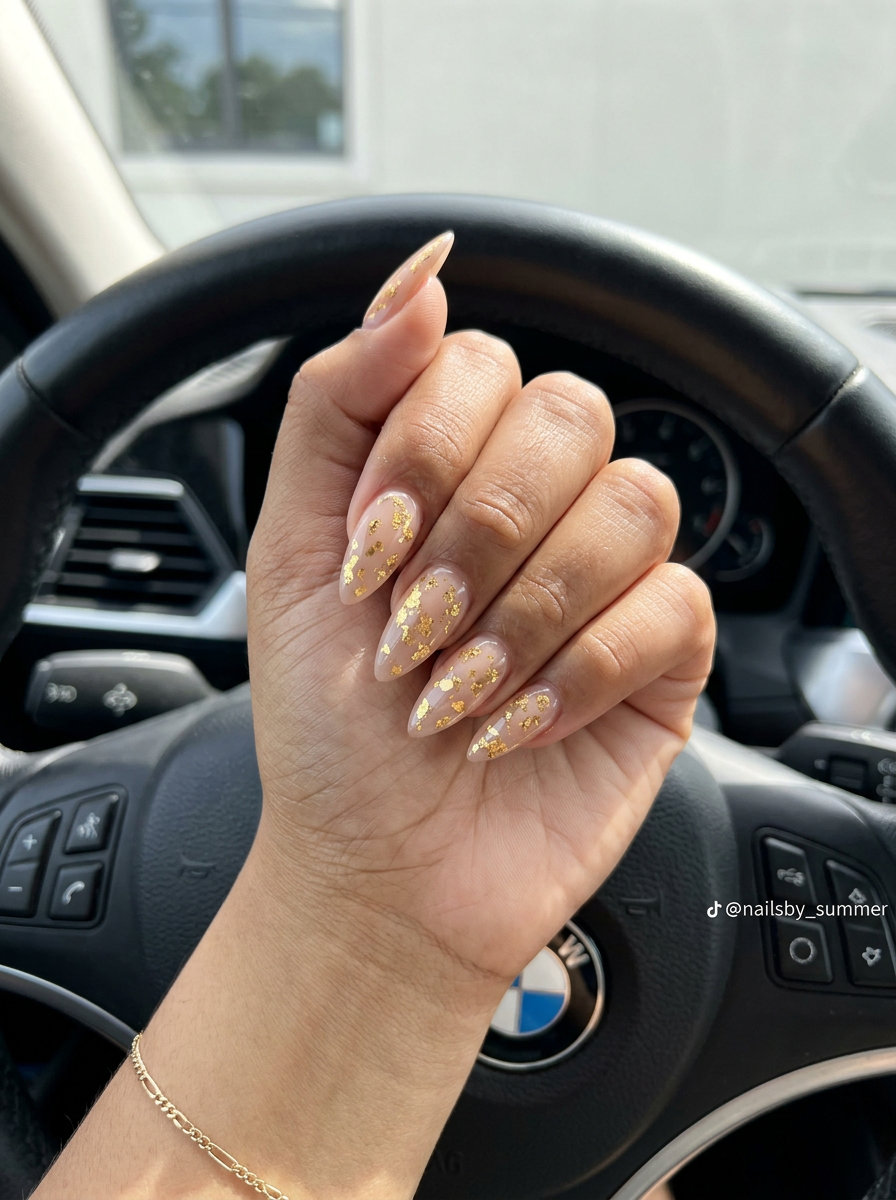 Gilded Summer Foil Stiletto nails: sheer nude with metallic gold flakes for vacation & cocktail parties.