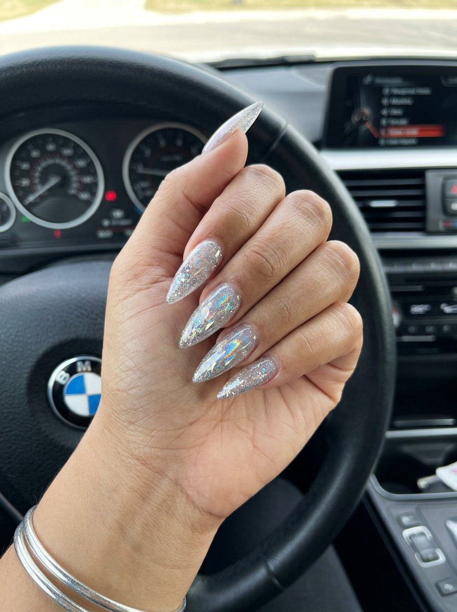 Crystal Shard Stiletto nails: Clear with silver glitter & holographic shift for festival, night out. Summer glitter nails 2026.